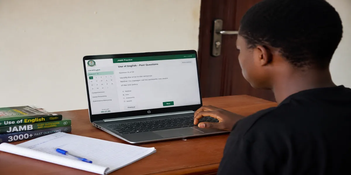 Nigerian student practising JAMB Use of English past questions on a laptop