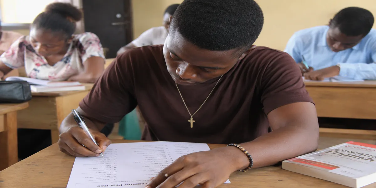 Nigerian student writing an essay using a structured template